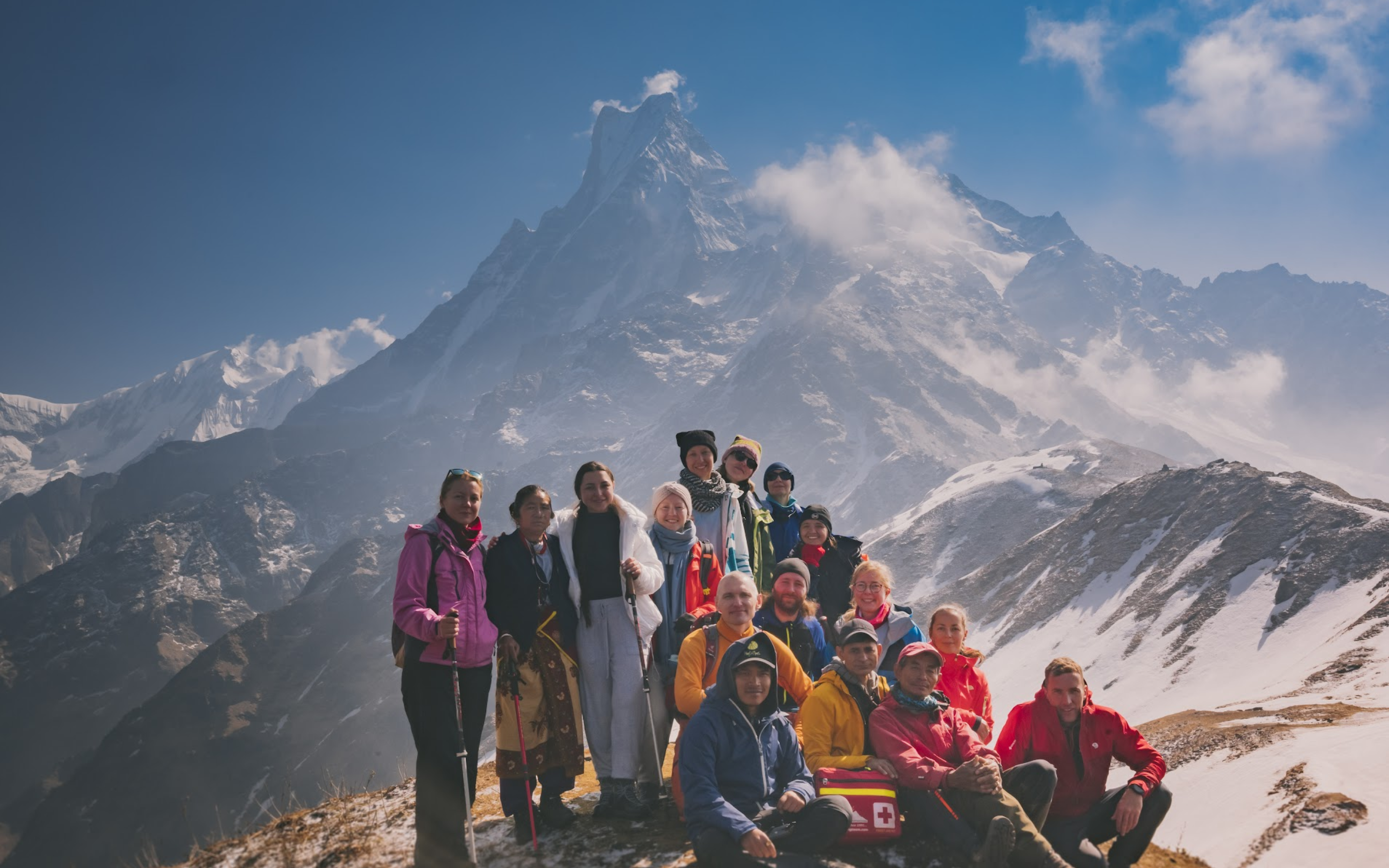 Tourists pose for picture on top of a mountain